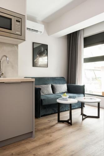 a living room with a couch and two tables at LUX&EASY Athens Downtown Apartments in Athens