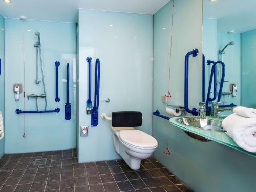 a bathroom with a toilet, sink, and shower stall at ibis Styles Barnsley in Barnsley