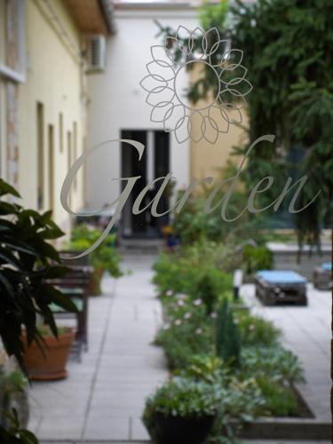 a garden with plants and a sign that reads garden at Margaréta Garden & SPA in Eger