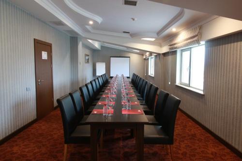 a long conference room with a long table and chairs at New Baku Hotel in Baku