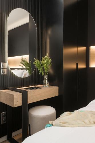 a bedroom with a vanity with a mirror and a bed at LUX&EASY Athens Downtown Apartments in Athens