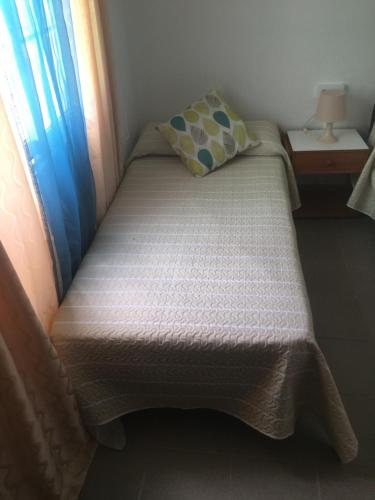 a small bed with a pillow and a window at Casa Angeles in Santa Cruz de la Palma