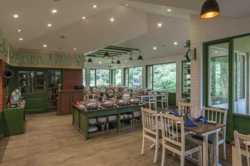 A restaurant or other place to eat at Club Mahindra Mount Serene, Munnar