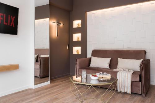 a living room with a couch and a table at LUX&EASY Athens Downtown Apartments in Athens