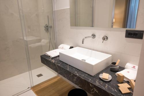a bathroom with a white sink and a shower at Santoro Country House in Castiglione di Sicilia