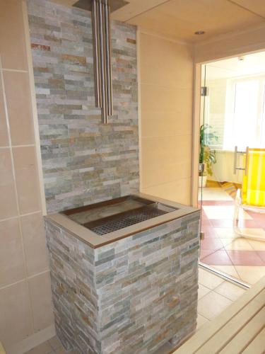 a stone counter in a room with a brick wall at JUFA Hotel Altaussee in Altaussee