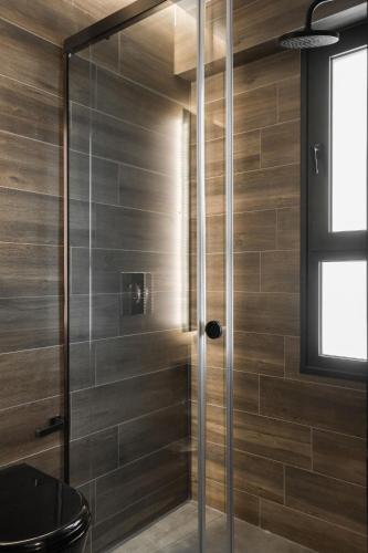 a shower with a glass door in a bathroom at LUX&EASY Athens Downtown Apartments in Athens