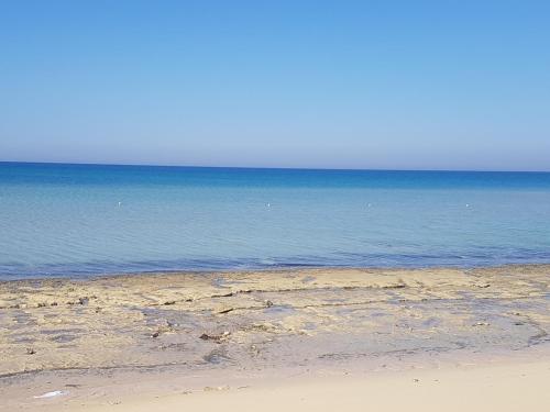 a sandy beach with the ocean in the background at Golden Beach 1 for family in Ras Sedr