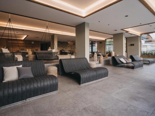 a lobby with couches and chairs in a building at VAYA Fieberbrunn inklusive Gästekarte in Fieberbrunn