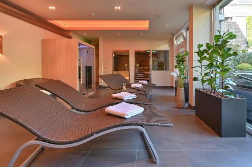 a waiting room with brown chairs in a building at Villa Ludwig Suite Hotel in Hohenschwangau