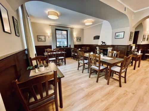 a dining room with wooden tables and chairs at Pension Silvie in Vlašim