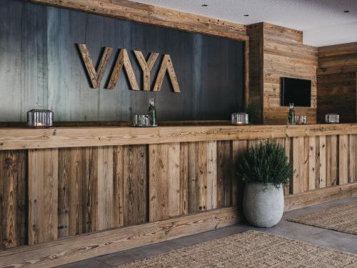 a wooden bar with a viva sign on a wall at VAYA Fieberbrunn inklusive Gästekarte in Fieberbrunn