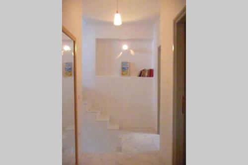 a hallway with a staircase in a house at Naousa Home with full sea views in Naousa