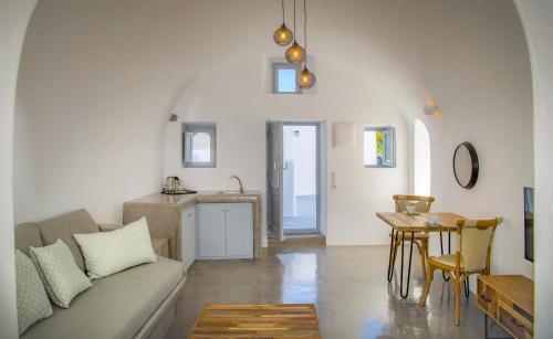 a living room with a couch and a table at AQUA SERENITY LUXURY SUITES SANTORINI in Foinikiá