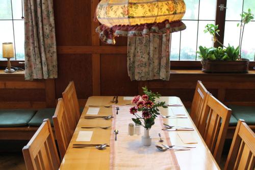 a dining room table with two chairs and a table cloth at Hotel Gasthof zur Linde in Rothenburg ob der Tauber