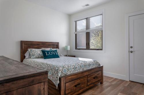 a bedroom with a bed and a window at Capri 106 in the Heart of Downtown Traverse City in Traverse City