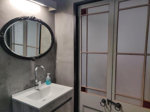 a bathroom with a sink and a mirror at Karkloof Hideout in Howick