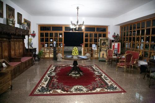 a living room with a table and a rug at Hotel La Riva in Giardini Naxos