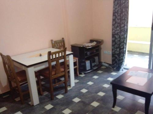 een eetkamer met een tafel en stoelen in een kamer bij Apartament in Shëngjin