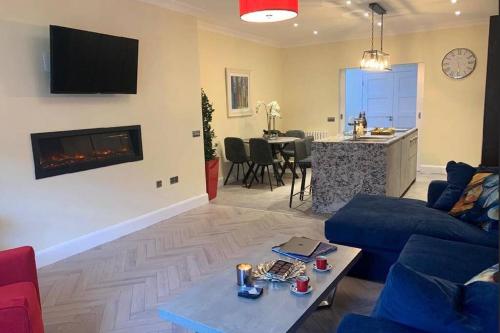 a living room with a blue couch and a fireplace at Apartment, Kilkenny City in Kilkenny