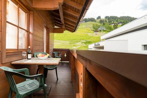 a balcony with a table and a view of a field at Appartements Bernhofer in Saalbach Hinterglemm