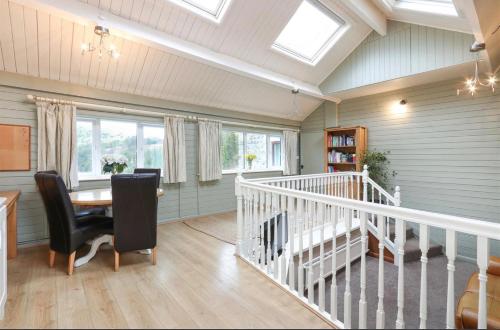 a home office with a staircase and a table and chairs at River View in Buxton