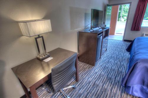 a hotel room with a bedroom with a bed and a television at Econo Lodge Helen in Helen