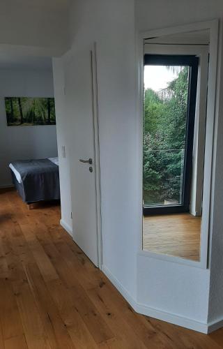 a room with a door to a bedroom with a window at Waldurlaub Klingelborn im Sauerland in Balve