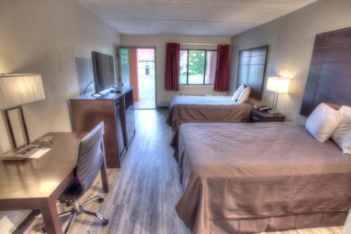 a hotel room with two beds and a television at Econo Lodge Helen in Helen