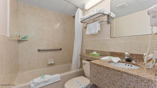 a bathroom with a sink and a toilet and a tub at Beau Rivage Beach Resort in Wildwood Crest