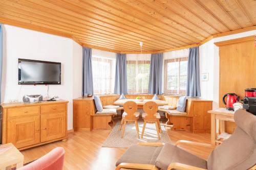 a living room with a couch and a table at Appartements Bernhofer in Saalbach Hinterglemm