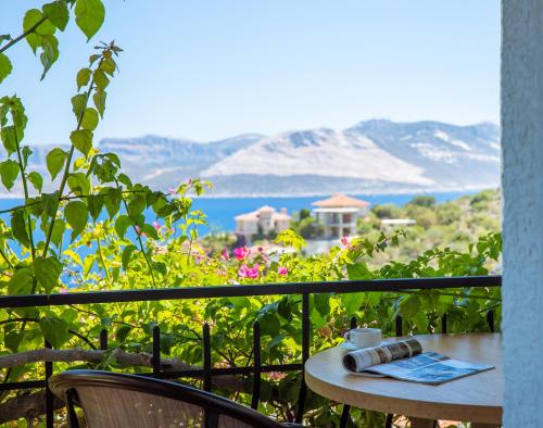 a table on a balcony with a view of the ocean at Hill House Adult Only in Kas