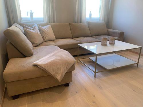 a living room with a couch and a coffee table at Notodden Sentrum Apartment NO 4 in Notodden