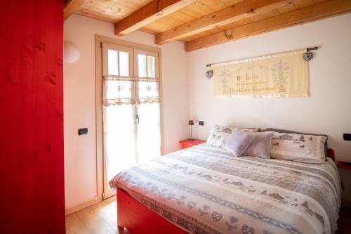 a bedroom with a large bed and a window at TRILOCALE ALPES: DIMENTICA L'AUTO E RILASSATI in Ponte di Legno