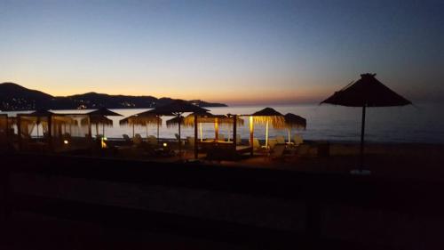 a group of umbrellas and chairs on a beach at Minoica Beach Apartments in Amoudara Herakliou