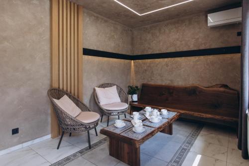 a room with a table and chairs and a piano at Hotel Vedmezhyi Dvir in Bukovel
