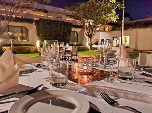 a table with plates and glasses on top of it at Trident Bhubaneswar in Bhubaneshwar