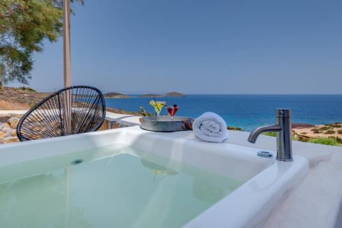 a kitchen sink with a view of the ocean at Faros Resort in Azolimnos Syros