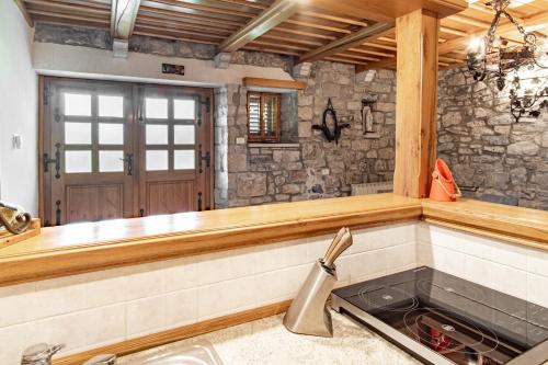 a kitchen with a sink and a counter top at Apartment Trieste HerMes arT in Sežana