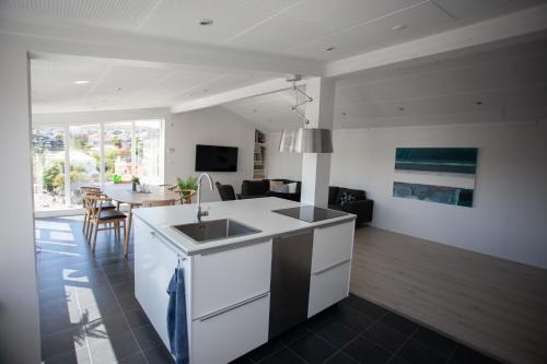 a kitchen and living room with a sink and a table at Apartments in Downtown Tórshavn in Tórshavn