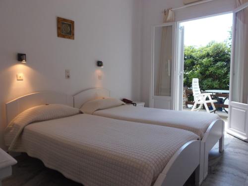 Ένα ή περισσότερα κρεβάτια σε δωμάτιο στο Hotel Manos 