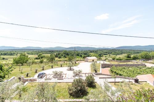 an aerial view of a farm with mountains in the background at Apartment Trieste HerMes arT in Sežana