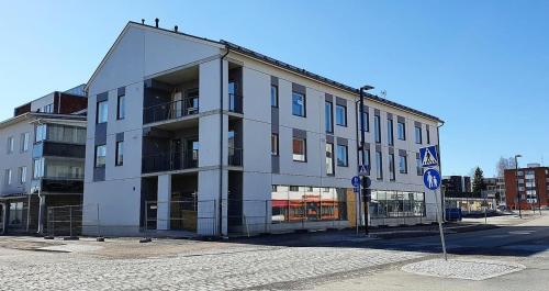 a large white building on the corner of a street at apartment Juurikoskenkatu in Ylivieska