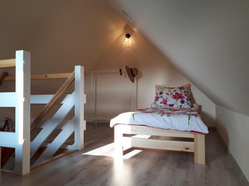 a small bedroom with a bed and a staircase at Domki Anusia Niechorze in Niechorze