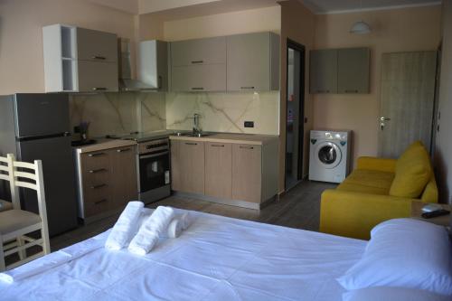 ヴロラにあるLungomare private roomsのベッドルーム1室(ベッド1台付)、キッチン(洗濯機付)