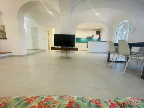 a large living room with a flat screen tv at Villa Cycas in Ischia