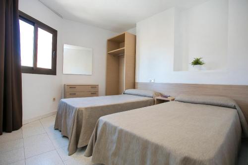 a hospital room with two beds and a window at Apartamentos Amalia By Mc in Benidorm