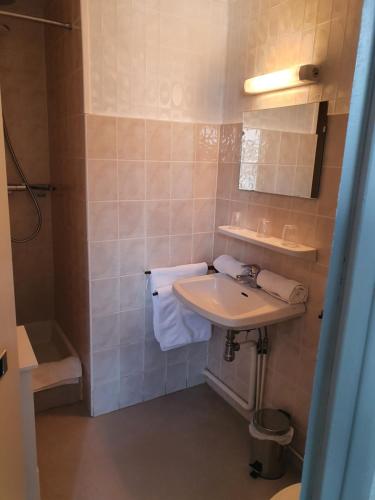 a bathroom with a sink and a shower at Hotel L'envie des mets in Lus-la-Croix-Haute