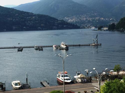 a group of boats docked at a dock on a lake at Hotel Barchetta Excelsior in Como
