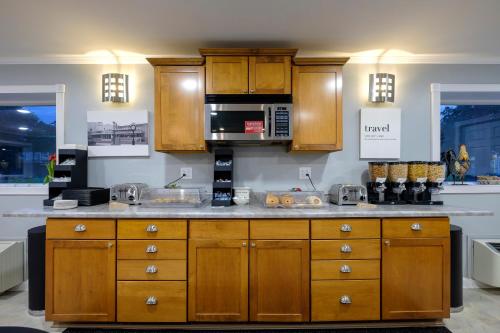 a kitchen with wooden cabinets and a counter top at Red Roof Inn and Suites Herkimer in Herkimer